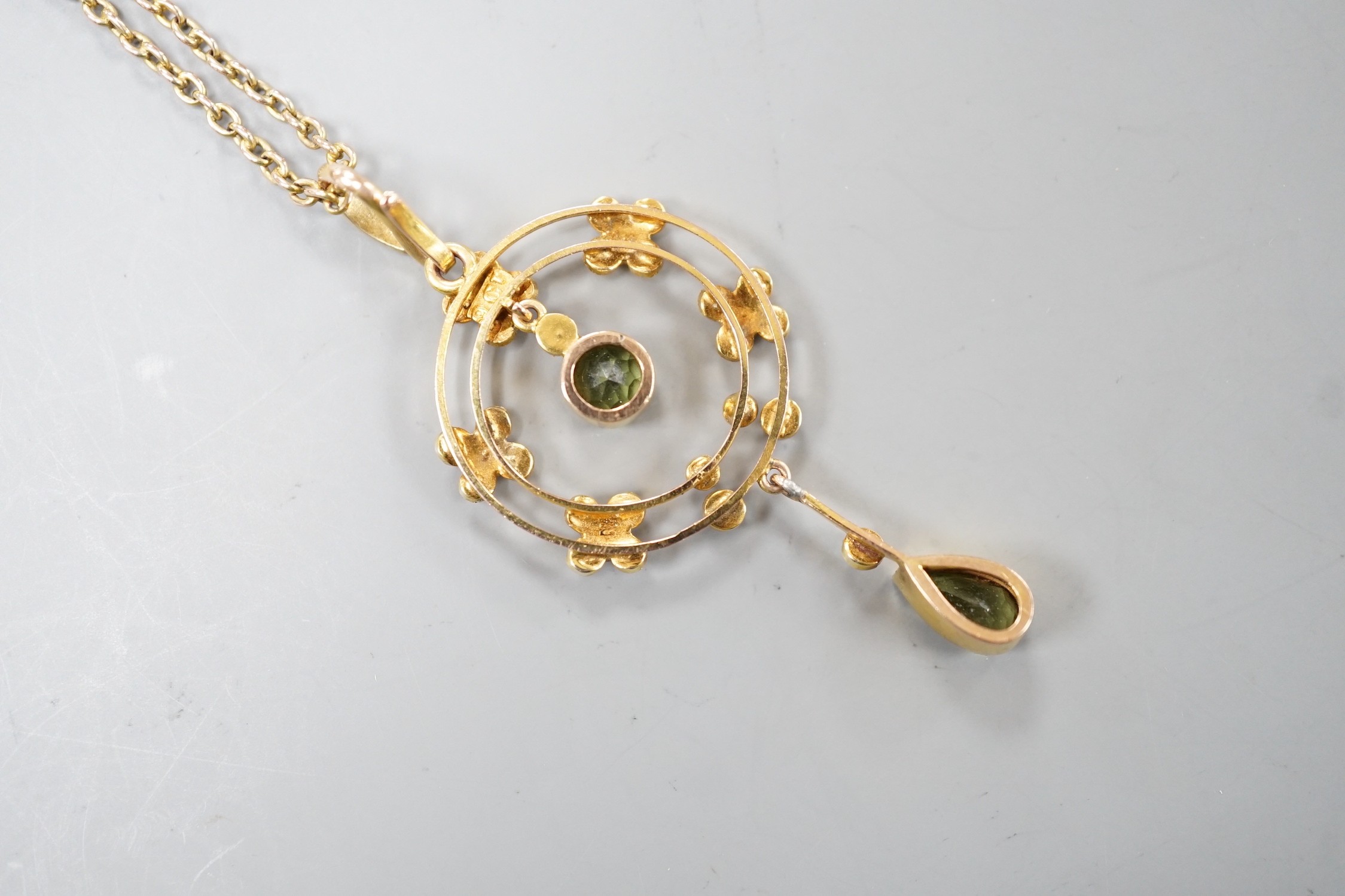 An Edwardian 9ct, peridot and seed pearl cluster set drop pendant necklace, pendant 49mm, chain 45cm